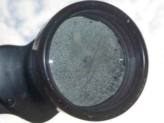 heavily fogged binocular lens