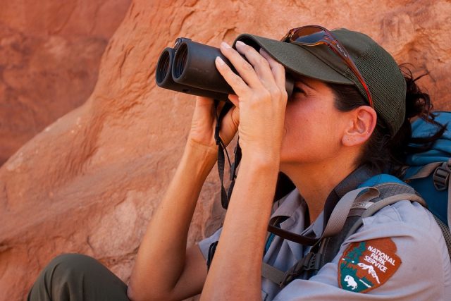 ranger using binoculars